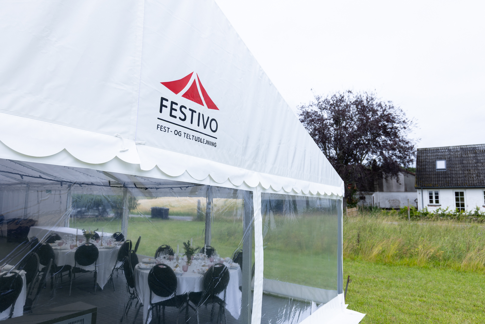 Eight shirts arranged on table in black, olive, grey, blue, white, red, mustard, and green.