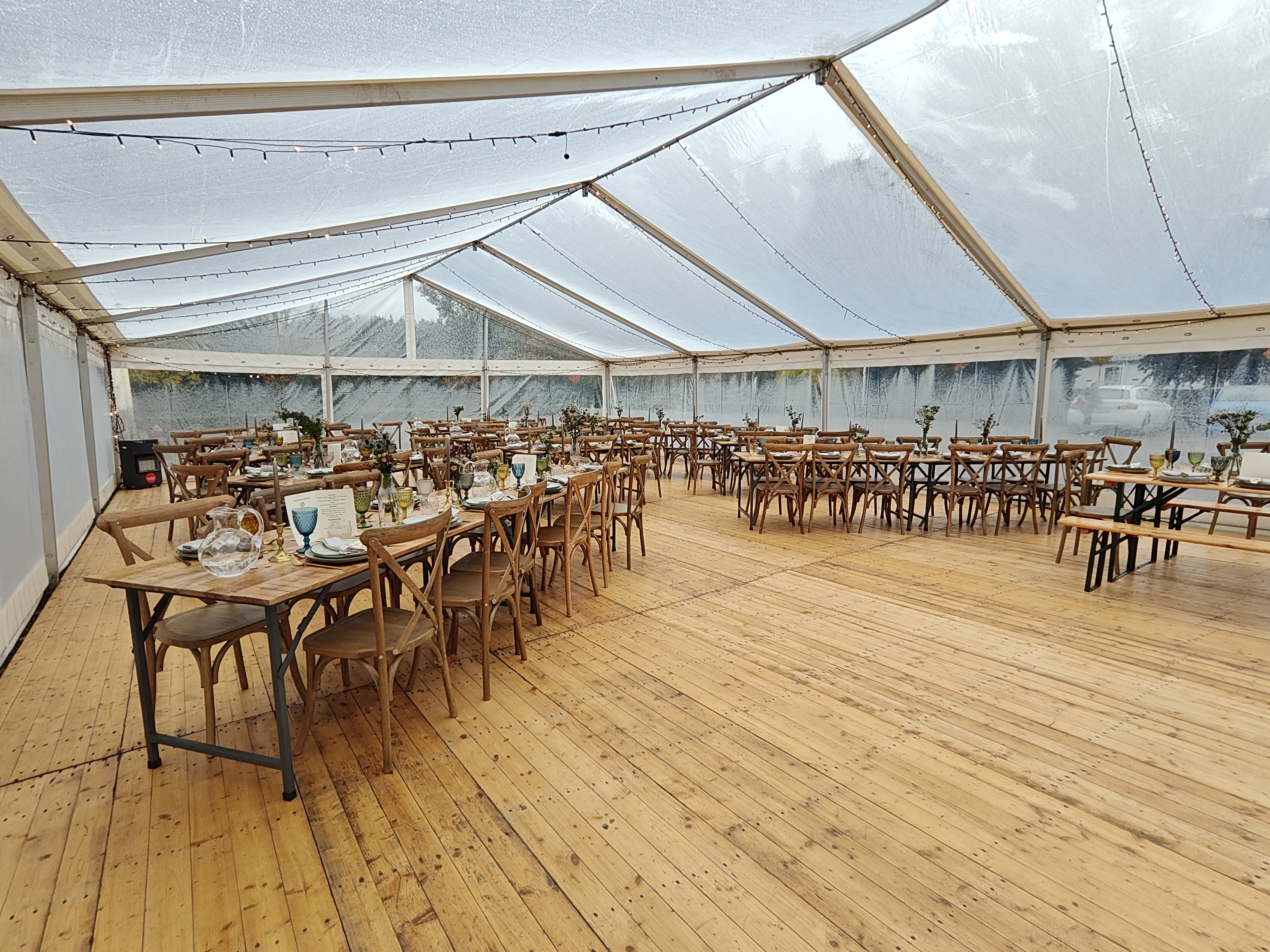 Eight shirts arranged on table in black, olive, grey, blue, white, red, mustard, and green.